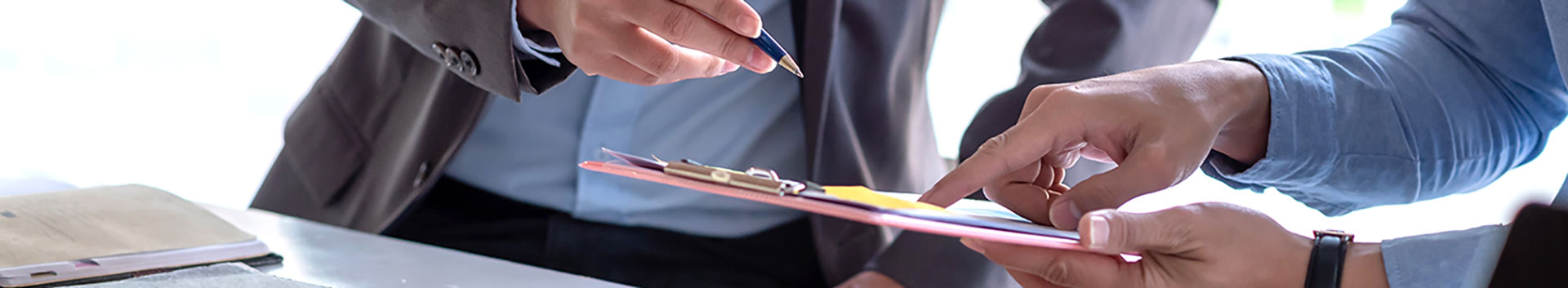 Photo of two people with pen and clipboard