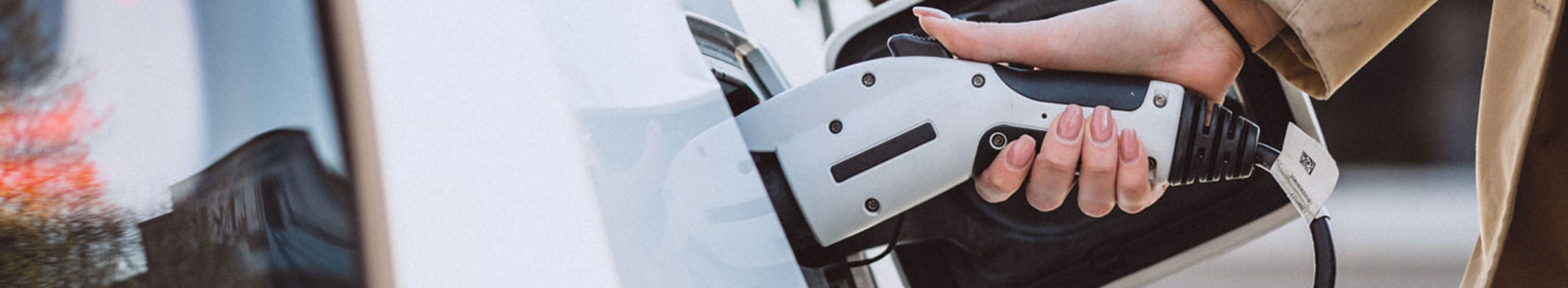 Photo of person plugging in a car