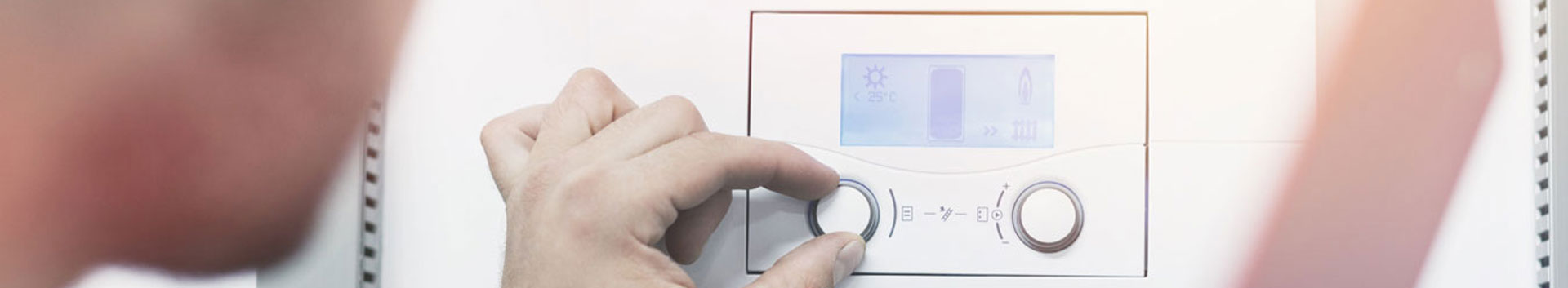 Photo of person adjusting thermostat