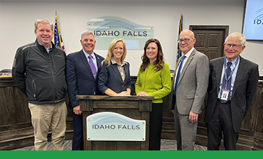 Idaho Falls City Council Stand around podium to sign energy contract