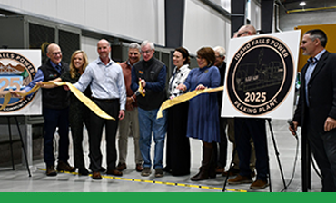 Idaho Falls City Leadership cuts gold ribbon in front of natural gas generators
