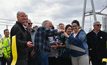 Photo of people cutting a ribbon at a substation.