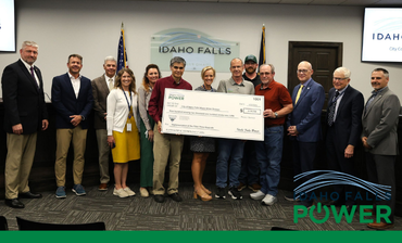 Photo of a group of people holding an oversized check
